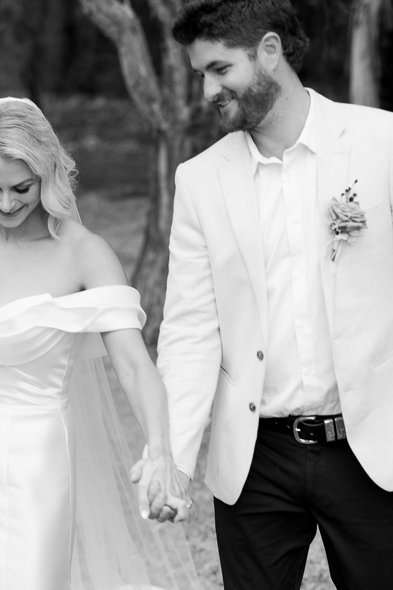 Kate and Nick sharing a joyful moment during their relaxed lakefront wedding ceremony at Kate's family home in Perth, captured by a Perth wedding photographer